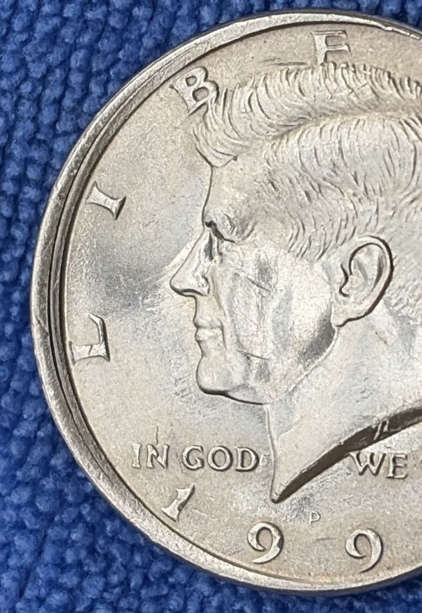 1991 Kennedy half dollar off-center strike error showing approximately 35% displacement with date visible