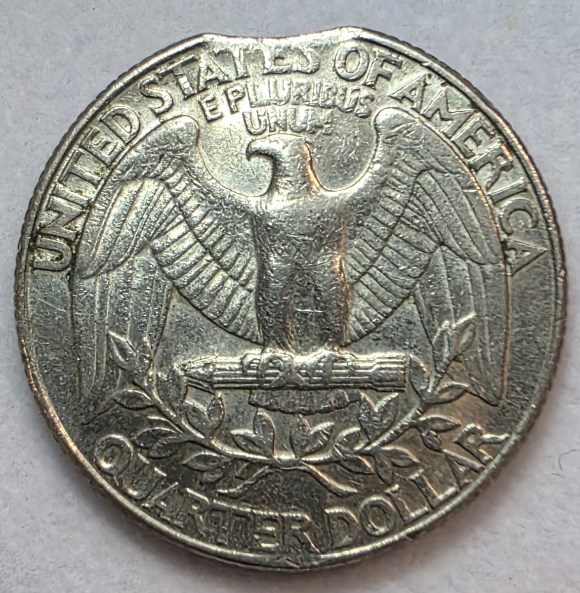 1991 Kennedy half dollar clipped planchet error showing curved clip in coin edge